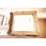 A SUBSTANTIAL GILT COMPOSITION PICTURE FRAME IN REGENCE STYLE,