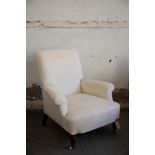 A VICTORIAN UPHOLSTERED ARMCHAIR, IN THE MANNER OF HOWARD & SONS,