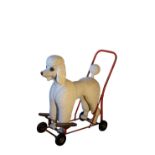 A MOULDED RESIN AND WROUGHT IRON MOUNTED PUSH-ALONG POODLE, BY TRI-ANG,