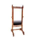 A GEORGE IV MAHOGANY AND PART EBONISED CHEVAL MIRROR, IN THE MANNER OF GILLOWS,