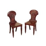 A PAIR OF REGENCY OR GEORGE IV MAHOGANY HALL CHAIRS, IN THE MANNER OF GILLOWS,