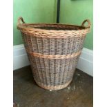 A SET OF THREE LARGE WICKER LOG BASKETS