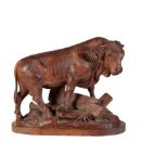 A FINE 'BLACK FOREST' CARVED AND STAINED LINDEN WOOD MODEL OF A BULL,