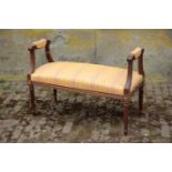 A MAHOGANY AND UPHOLSTERED WINDOW SEAT, IN EMPIRE STYLE,