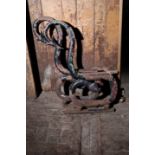 A PAIR OF VICTORIAN CAST IRON GARDEN BENCH ENDS CAST AS SERPENTS,