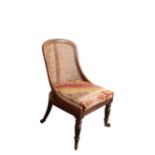A REGENCY ROSEWOOD AND CANEWORK LIBRARY SLIPPER BERGERE, POSSIBLY BY GILLOWS,
