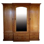 A VICTORIAN SATINWOOD BREAKFRONT WARDROBE, BY HOLLAND & SONS,