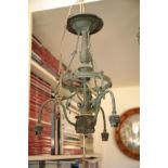 AN EDWARDIAN VERDIGRIS PATINATED METAL THREE LIGHT ELECTROLIER,