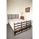 A CARVED WALNUT DOUBLE BED, BY HEAL & SON,