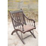 A VICTORIAN OAK AND PINE ELBOW CHAIR IN REFORMED GOTHIC STYLE,