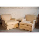 A PAIR OF UPHOLSTERED ARMCHAIRS IN THE MANNER OF HOWARD & SONS,