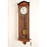 A CONTINTNTAL WALNUT AND EBONISED WALL TIMEPIECE, IN THE MANNER OF A VIENNA REGULATOR,