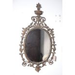 A CARVED AND GILTWOOD FRAMED OVAL WALL MIRROR, IN 18TH CENTURY STYLE,