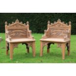 A PAIR OF VICTORIAN CARVED OAK HALL CHAIRS, IN GOTHIC STYLE,