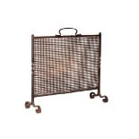 A WROUGHT IRON AND LATTICED METAL SPARK GUARD,