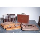 THREE VARIOUS LEATHER BRIEFCASES,