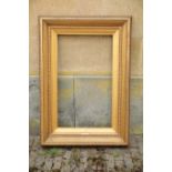 A GILT COMPOSITION PICTURE FRAME IN DIRECTOIRE STYLE,