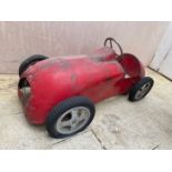 A CHILD'S PAINTED METAL PEDAL CAR MODELLED AS A RACING CAR,