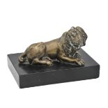 A CONTINENTAL BRONZE MODEL OF A RECUMBENT LION,