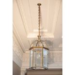 A BRASS AND GLAZED HALL LANTERN, IN LATE GEORGE III STYLE,