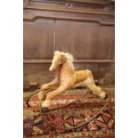 A HORSEHIDE COVERED ROCKING HORSE,