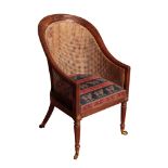 A REGENCY MAHOGANY AND CANEWORK LIBRARY BERGERE, ALMOST CERTAINLY BY GILLOWS,