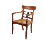 AN ANGLO COLONIAL TEAK LIBRARY ELBOW CHAIR,