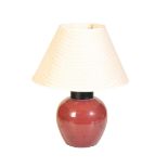 A SANG DE BOUEF GLOBULAR JAR FITTED AS A TABLE LAMP,