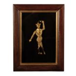 A GILT METAL FIGURAL RELIEF MODELLED AS A DANCING MAN,