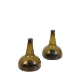 A PAIR OF ENGLISH GLASS WINE BOTTLES, 18TH CENTURTY