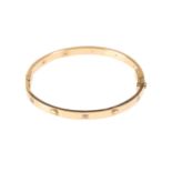 A CARTIER STYLE YELLOW GOLD LOVE BANGLE