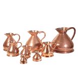 AN ASSOCIATED GROUP OF EIGHT VICTORIAN COPPER 'HAYSTACK' WINE MEASURES,