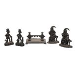 A SET OF FOUR VICTORIAN PUNCH CAST IRON DOOR STOPS