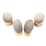 A SET OF FOUR MATCHED SILVER DRESSING BRUSHES,
