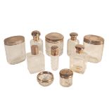 A COLLECTION OF SILVER LIDDED DRESSING-TABLE JARS