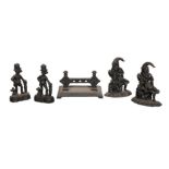 A SET OF FOUR VICTORIAN PUNCH CAST IRON DOOR STOPS