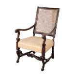 A 17TH CENTURY STYLE STAINED BEECH, WALNUT, AND CANED ARMCHAIR