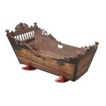 A 19TH CENTURY OAK AND POLYCHROME CRADLE,