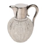 A SILVER-PLATED AND CUT-GLASS CLARET JUG