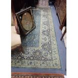 A LARGE GREEN GROUND PERSIAN DESIGN RUG