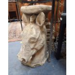A RECONSTITUTED STONE GARDEN STAND IN THE FORM OF AN HORSE'S HEAD