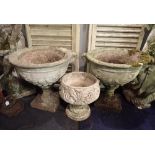 A PAIR OF RECONSTITUTED STONE GARDEN URNS