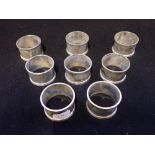 A SET OF EIGHT SILVER NAPKIN RINGS