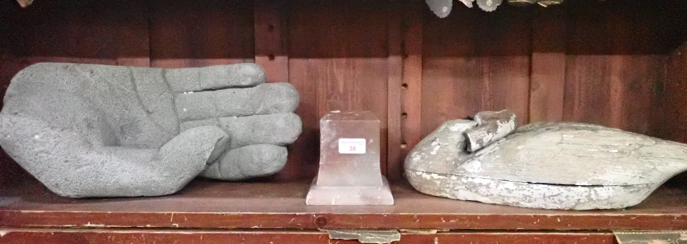 A STYLISED CARVING OF A HAND, IN A PUMICE-LIKE MATERIAL
