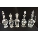 A PAIR OF CUT GLASS DECANTERS with faceted bodies