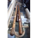A HARDWOOD POLICE TRUNCHEON, AND FOUR WALKING STICKS