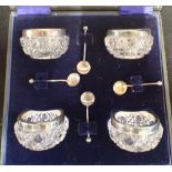 A SET OF FOUR CUT GLASS AND SILVER MOUNTED SALTS