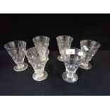A SET OF SIX CONICAL GLASS DRINKING GLASSES
