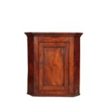 A GEORGE III ELM HANGING CORNER CABINET