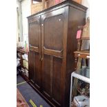 A 1920'S OAK DOUBLE WARDROBE